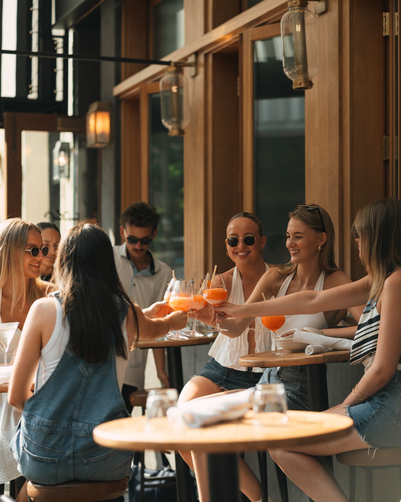Friends toasting cocktails on the patio