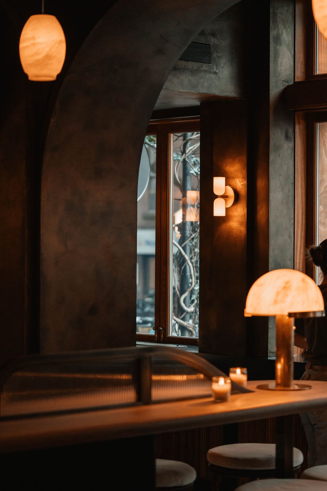 Candlelit archway and lantern light inside The Rhymers' Club